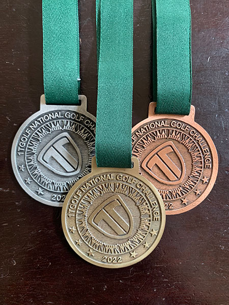 Gold, silver and bronze custom golf tournament medals with green ribbons